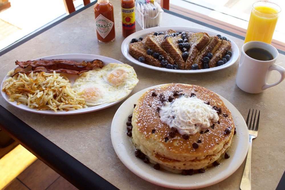 Silver Pancake in Warson Woods s a top St Louis breakfast spot. Photo of pancakes, french toast and classic eggs/bacon/hash brown plate.